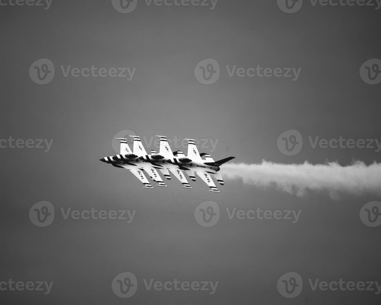Airshow of military jet fighters. Group of military airplanes performs maneuvers with a smoke trace. Aviation background photo