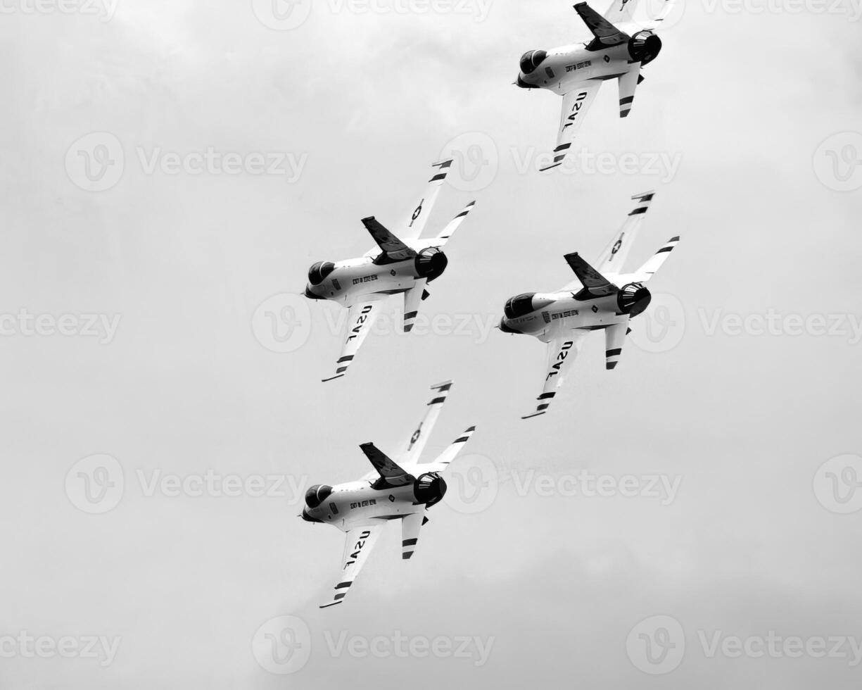 Airshow of military jet fighters. Group of military airplanes performs maneuvers with a smoke trace. Aviation background photo