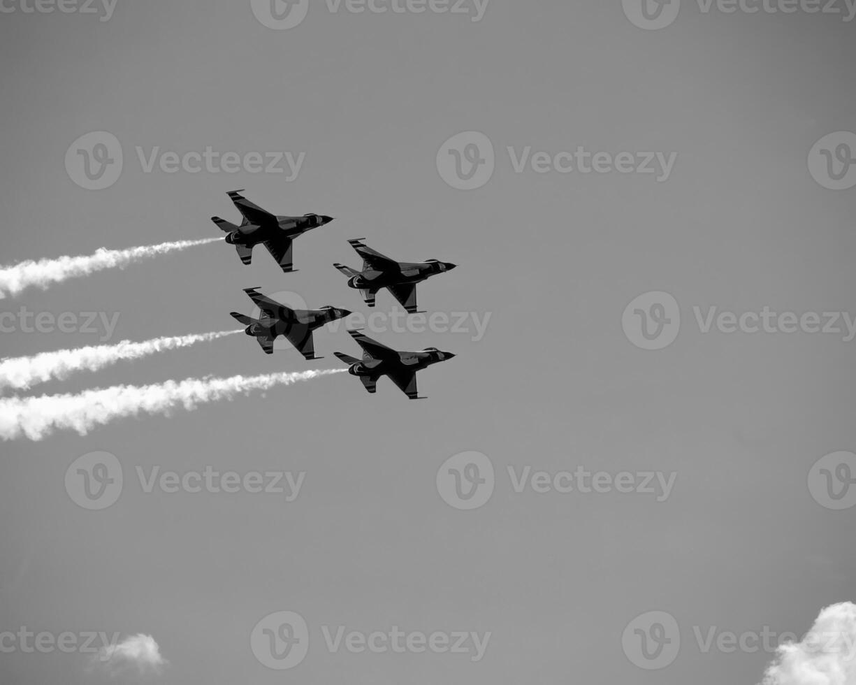 Airshow of military jet fighters. Group of military airplanes performs maneuvers with a smoke trace. Aviation background photo
