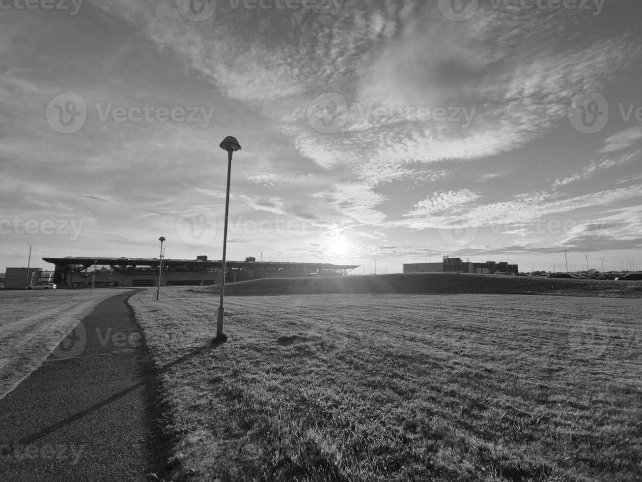 Dusk Sky Over Grassland with Plants and Clouds photo