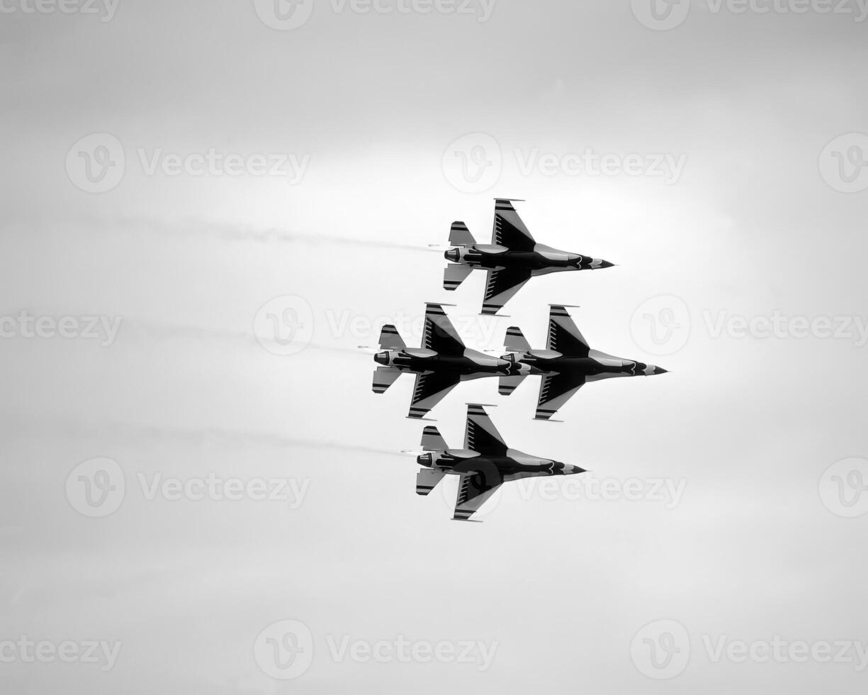 Airshow of military jet fighters. Group of military airplanes performs maneuvers with a smoke trace. Aviation background photo