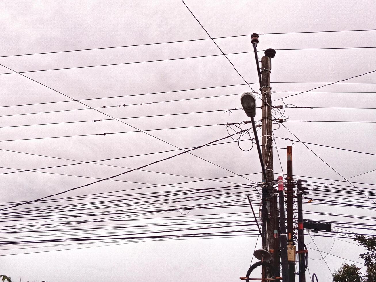 Electric cables crisscrossing and cloudy afternoon sky in the background.jpg photo