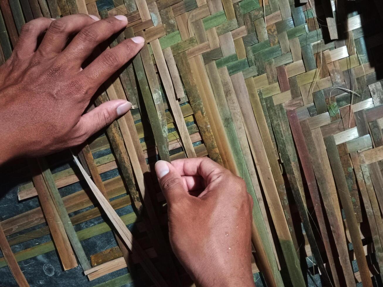 Hands of a man weaving bamboo, handicraft from ASEAN photo