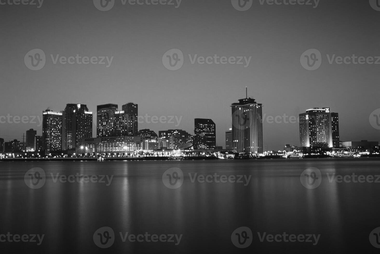Reflections of a Skyscraper at Dusk over a Serene Lake photo
