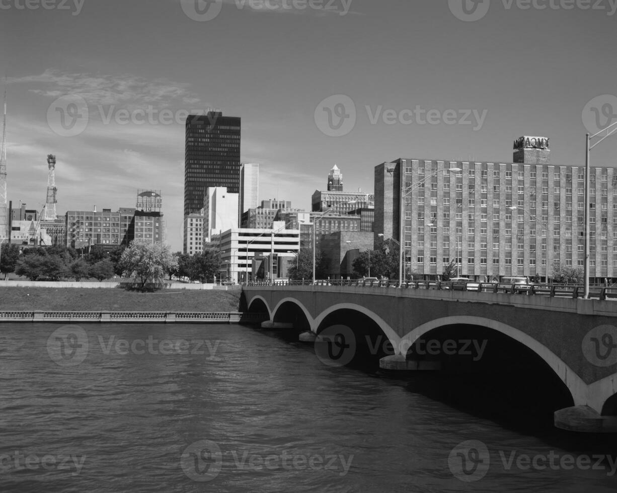Majestic Cityscape Reflected in Serene Waters Under a Cloudy Daytime Sky photo