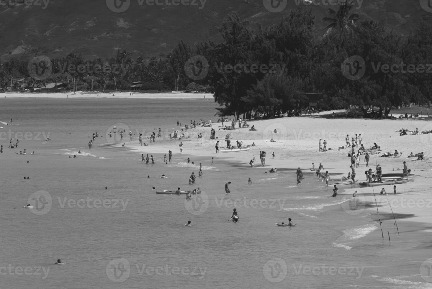 Relaxing Day at the Beach People Enjoying the Sun and Sea Amidst Coastal Scenery photo