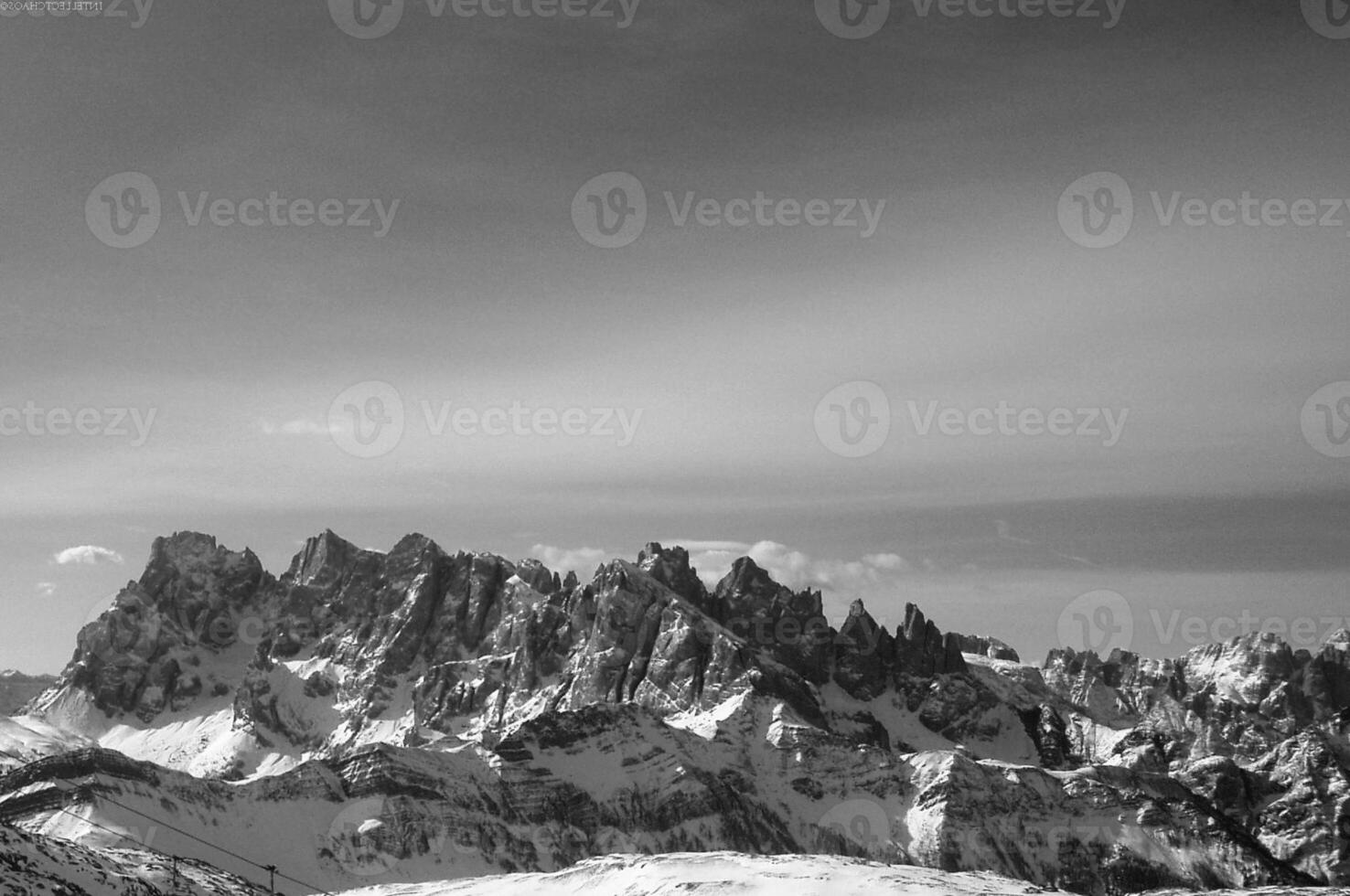 Snowy Mountain Landscape with Clouds in the Sky photo