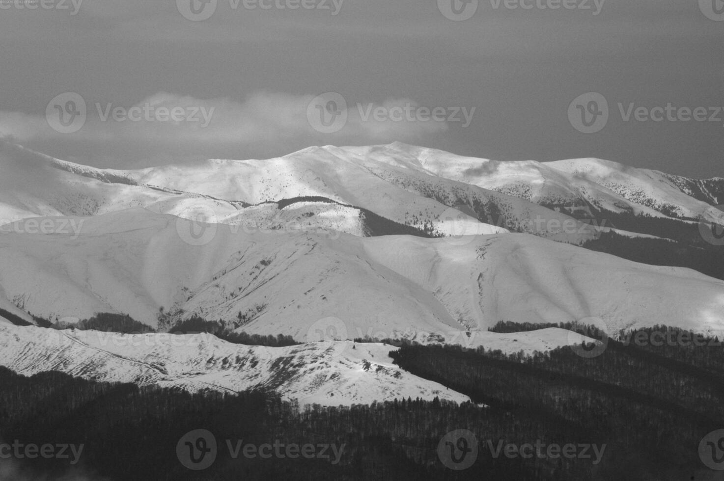 Snow-Capped Mountain Landscape under Cloudy Sky photo