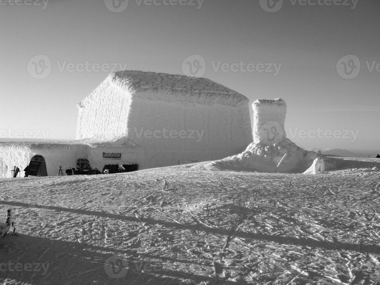 Snowy Slope with Ice Cap and Vehicle Under Sky photo