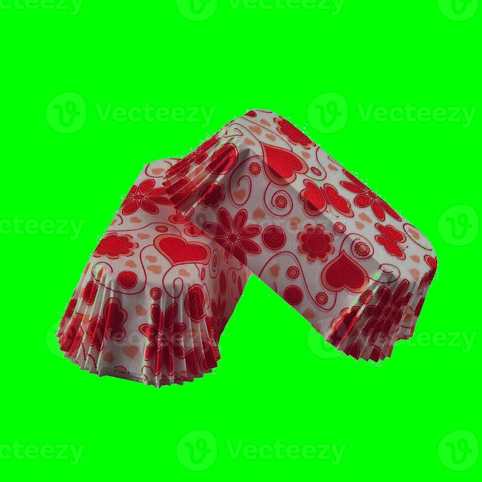 White paper baking forms for cakes with lovely hearts pattern. Green screen chroma key background photo
