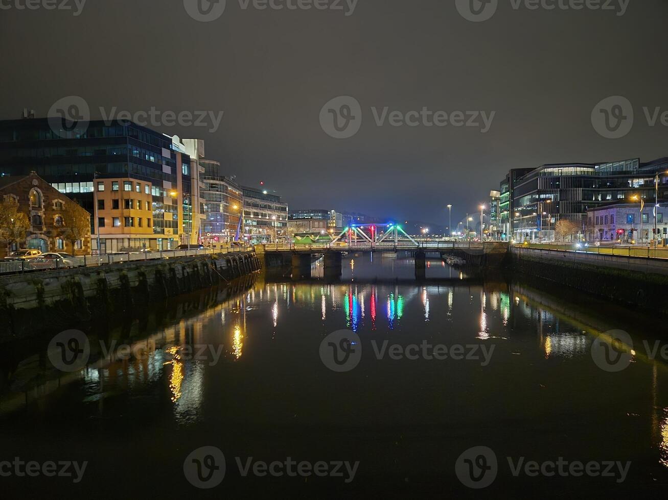Cityscape at Dusk with Water, Sky, and Tower Block Reflections photo