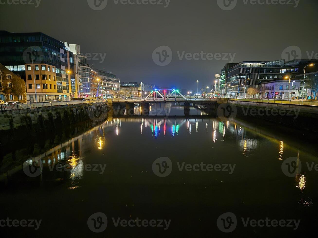 Cityscape with Building and Bridge Over Lake During Daytime photo