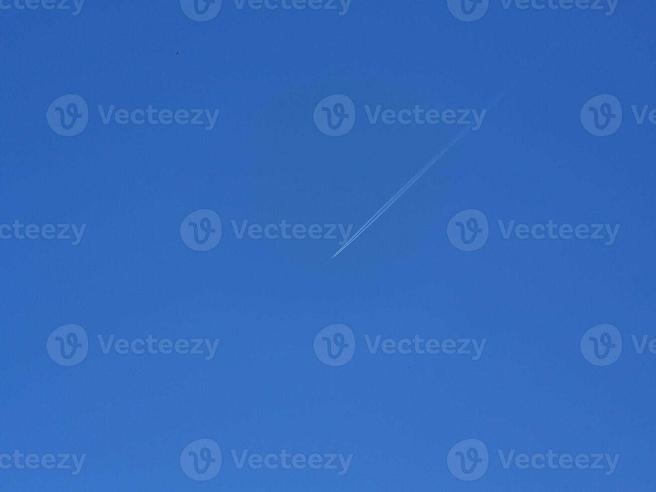 White airplane trail in the summer sky background photo