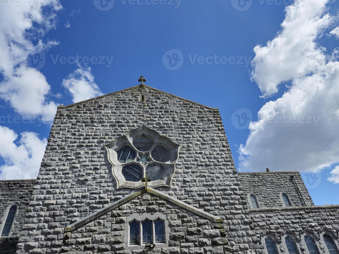 Cumulus Clouds Over a Blue Sky and Building Window photo