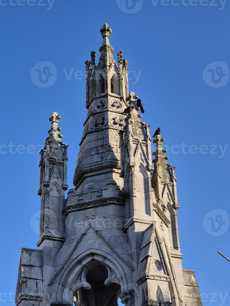 Medieval Architecture Tower with Sculpture and Steeple photo