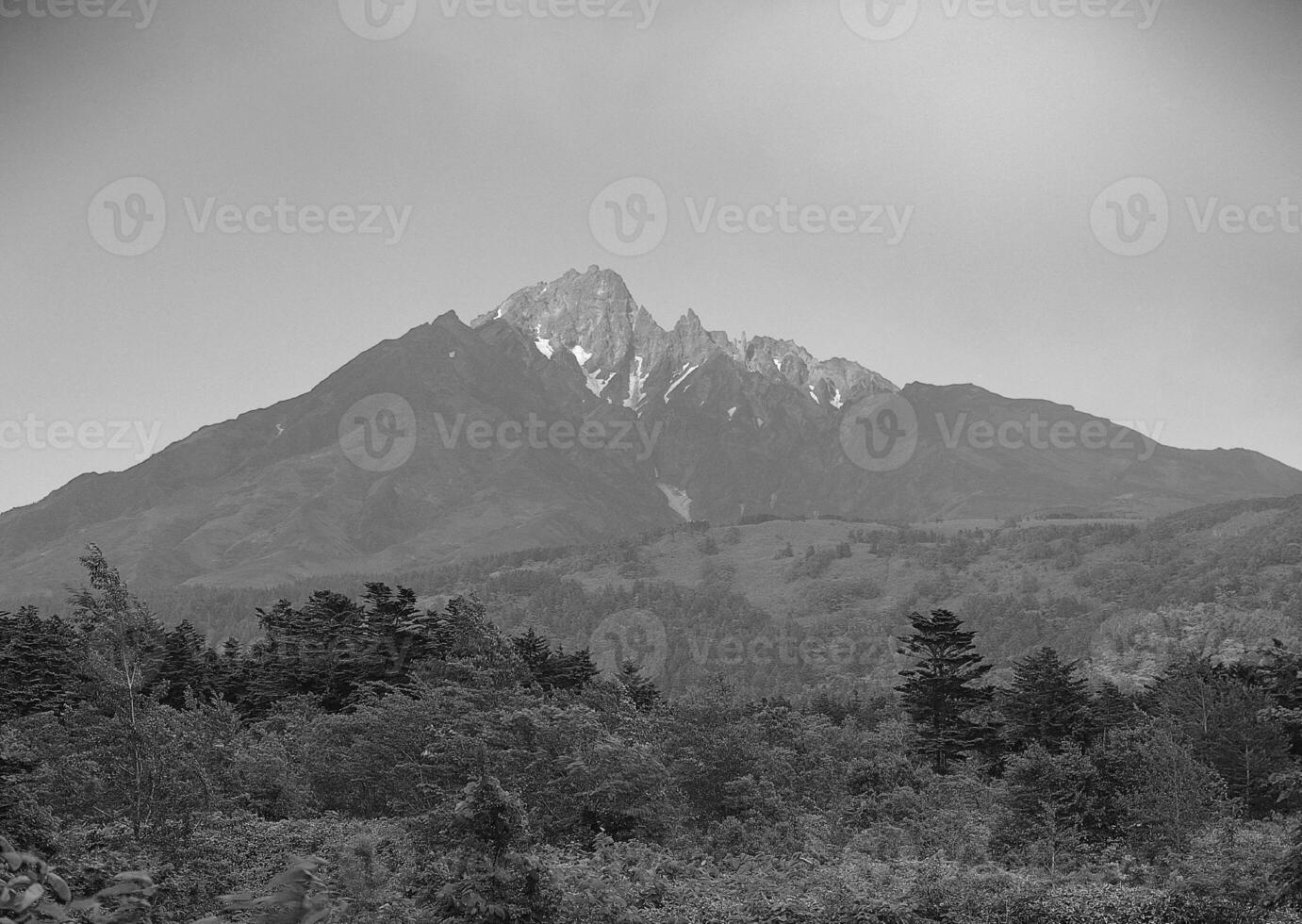 Majestic Highland Landscape with Lush Grasslands and Towering Mountains under a Beautiful Sky photo