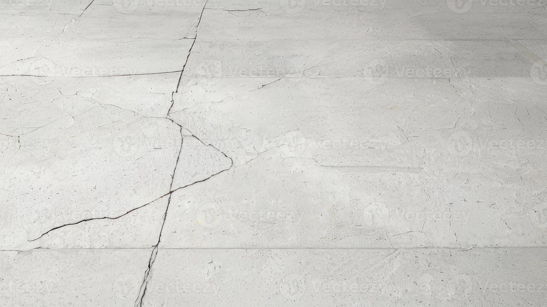 A white concrete floor with cracks in it photo