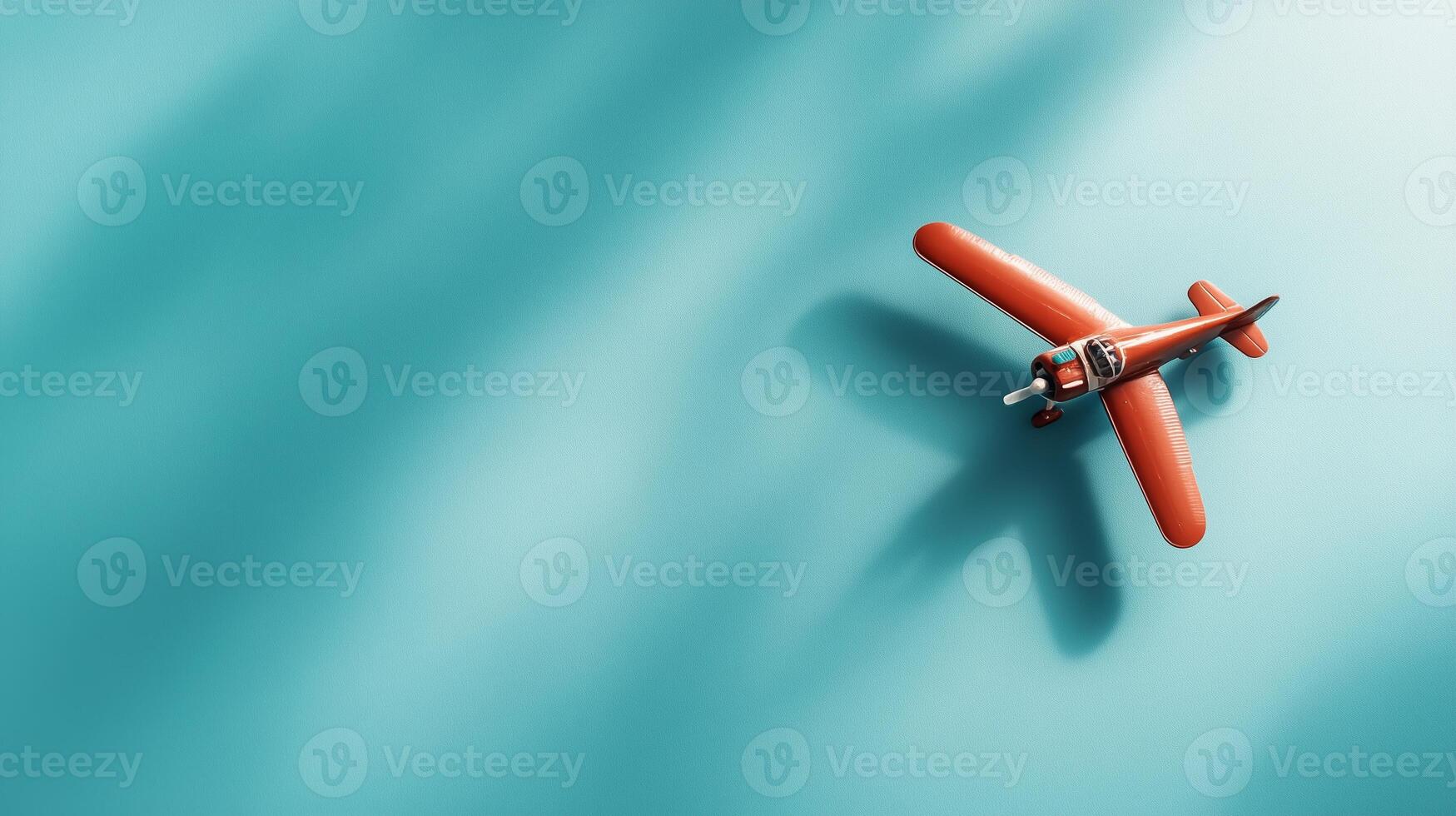 Vintage toy airplane glides over a bright turquoise background, showcasing craft and nostalgia in a playful display photo
