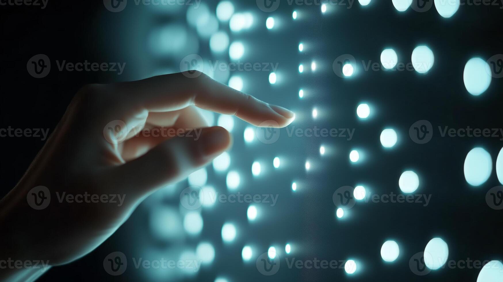 Digital interaction with illuminated light patterns in a dark environment during an immersive technological experience photo