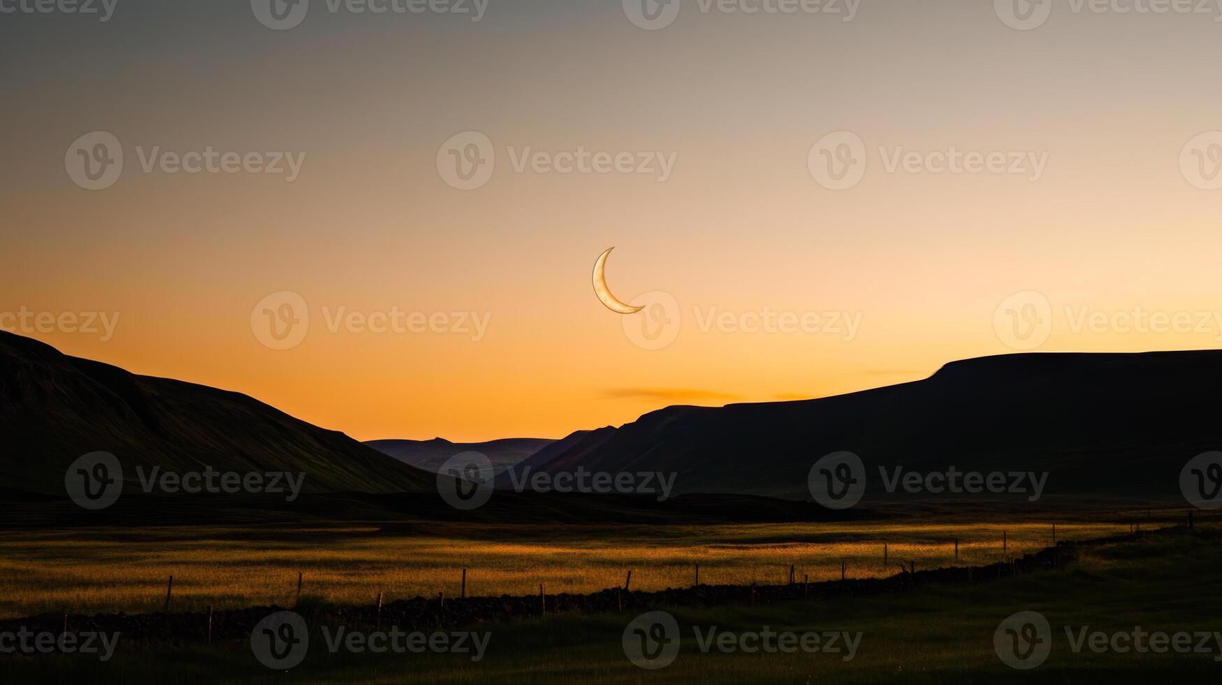Stunning crescent moon sets against a tranquil landscape at dusk near mountainous terrain photo