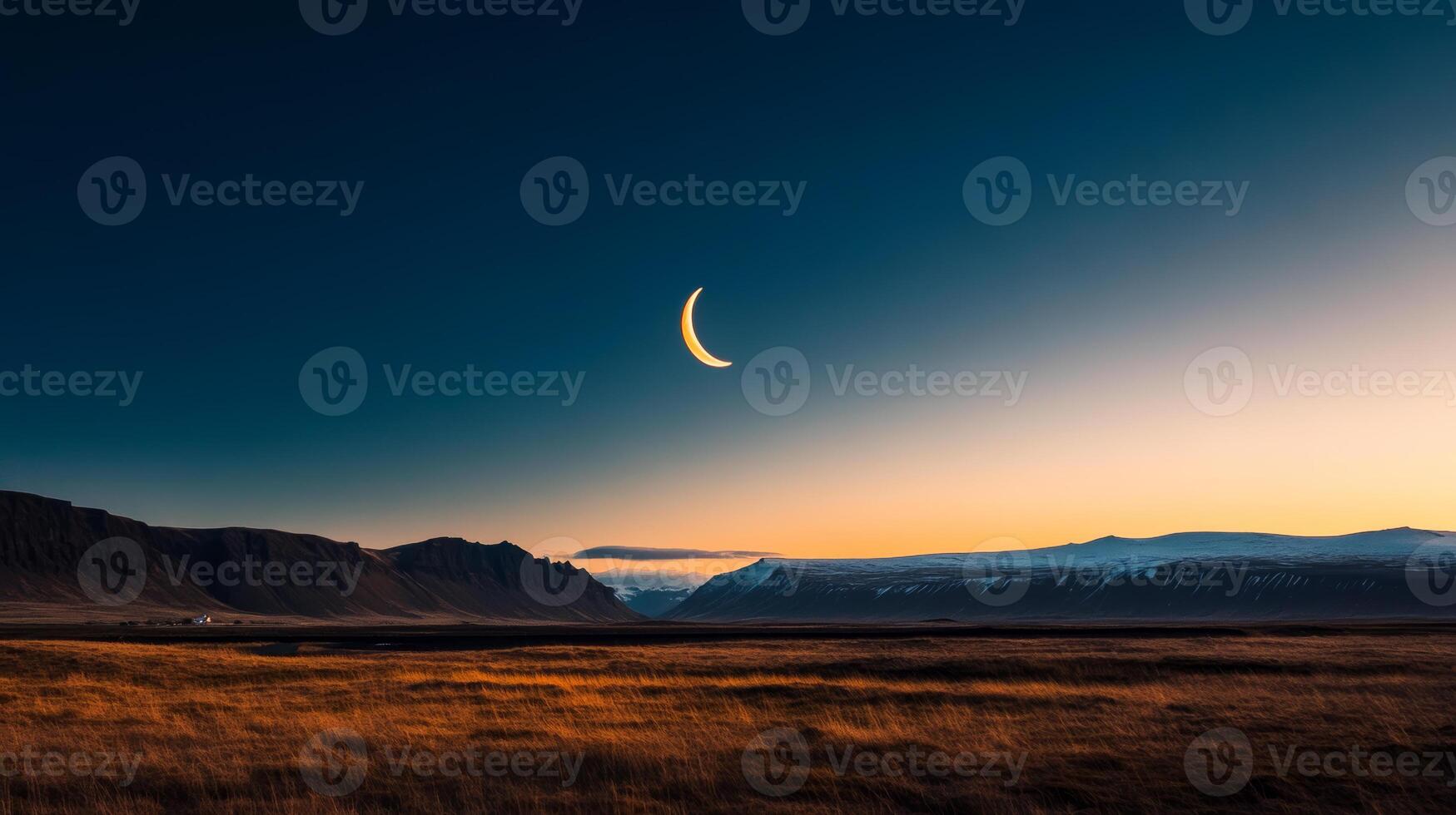 Vast landscape under a crescent moon at dusk with mountains in the background photo
