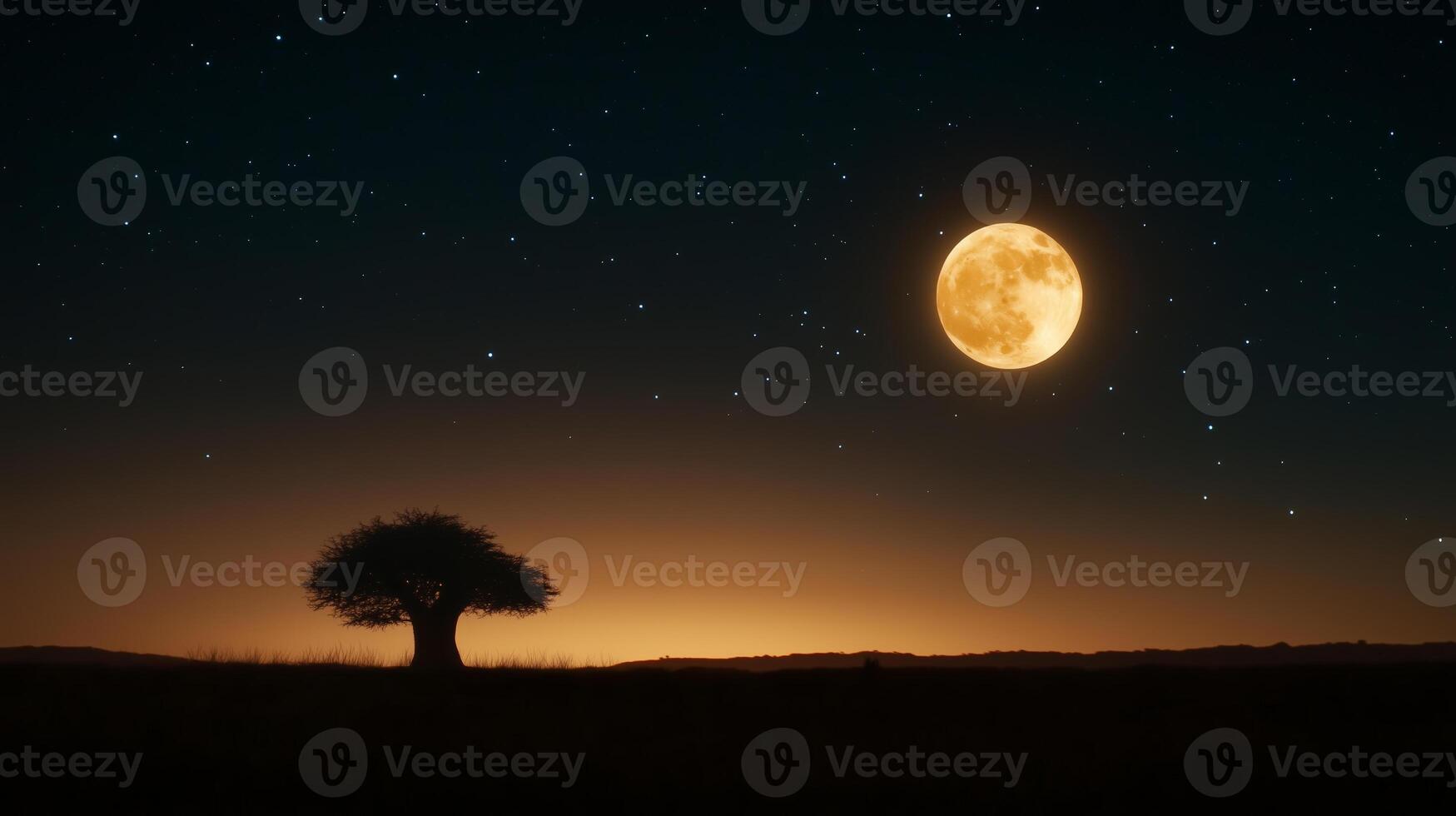 Majestic full moon shining over a silhouette of a lone tree in the peaceful twilight sky photo
