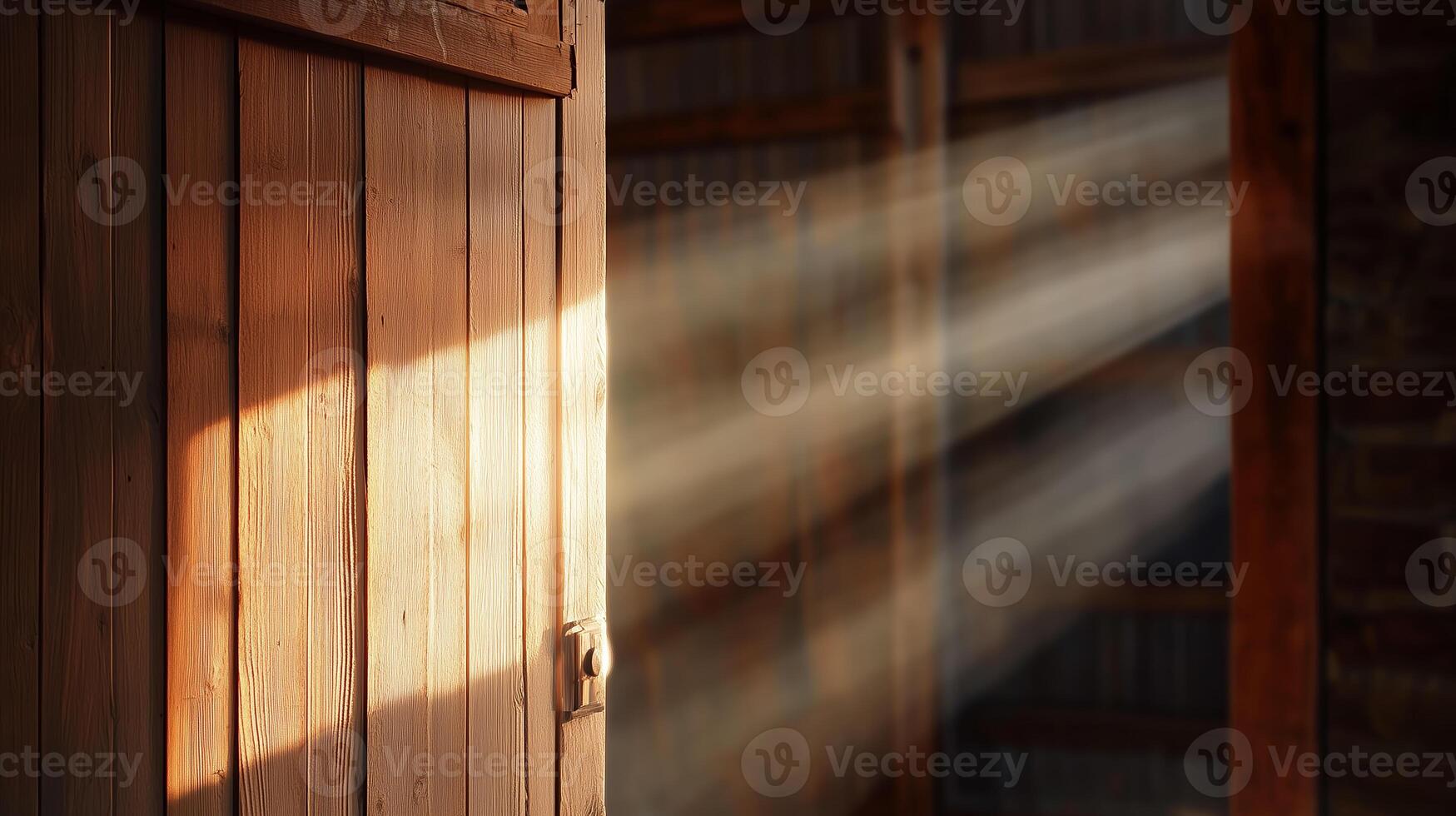 Light streams through an open wooden door in a rustic barn, creating a warm and inviting atmosphere photo