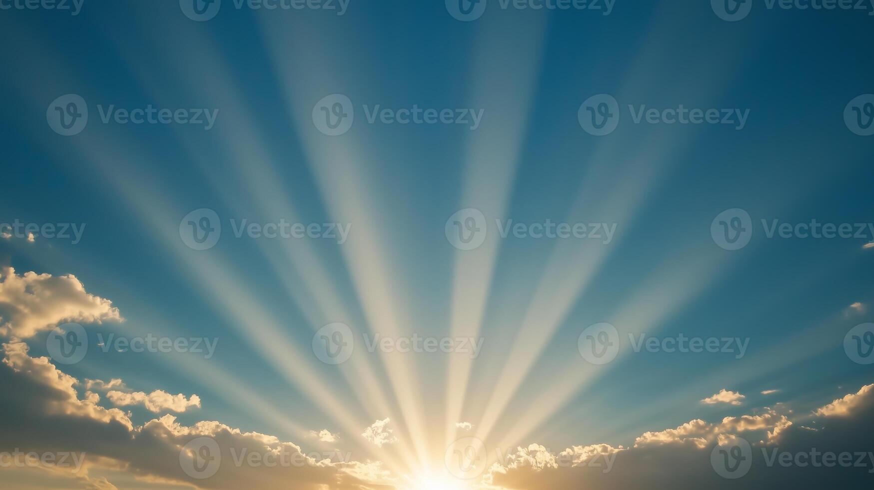 Bright rays of sunlight break through clouds in a tranquil sky at dawn, signaling the start of a new day photo