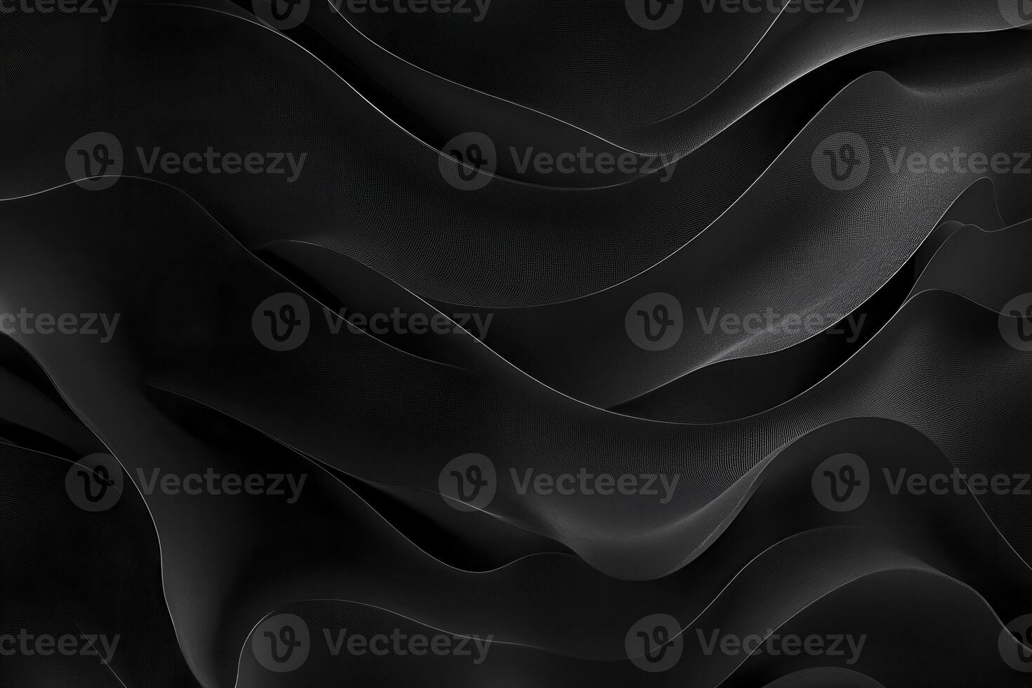 Smooth black waves flowing gracefully across a dark background creating an abstract pattern of light and shadow photo