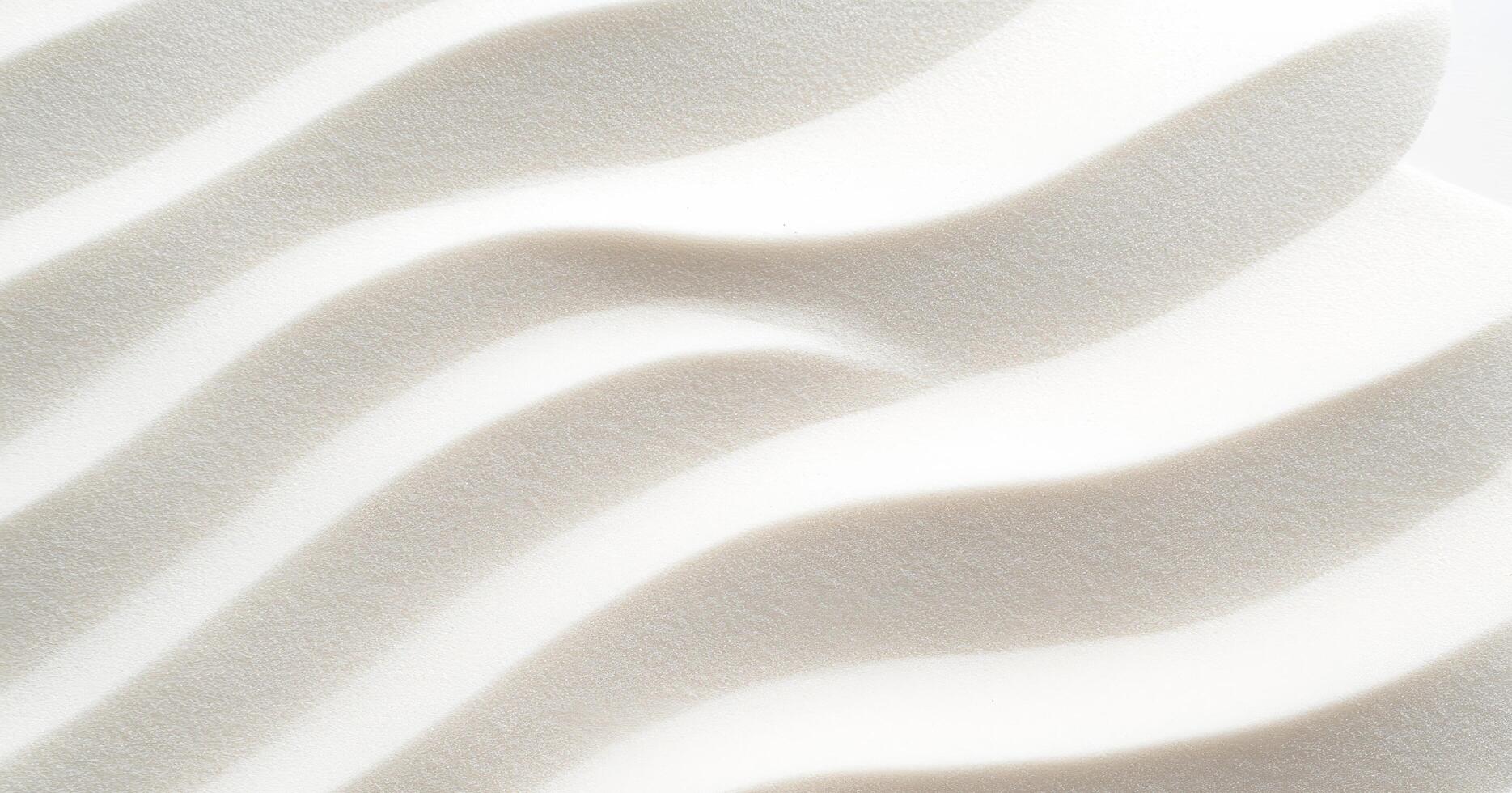 Smooth white sand with gentle wave patterns creates minimalistic and serene texture photo