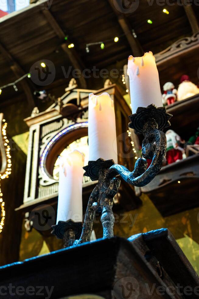 A huge candlestick and candles on it. 3 candles on a candlestick, New Year photo