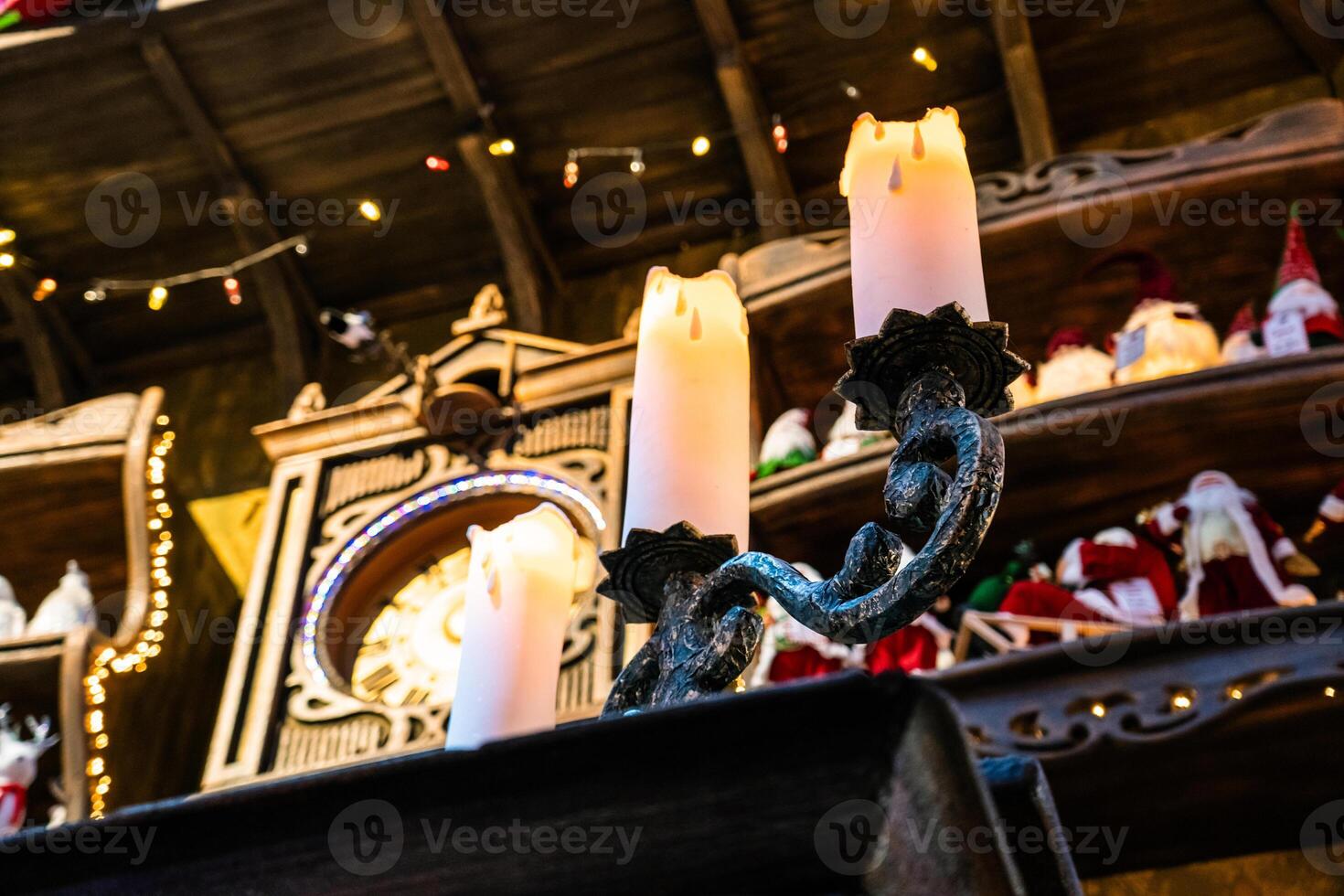 A huge candlestick and candles on it. 3 candles on a candlestick, New Year photo