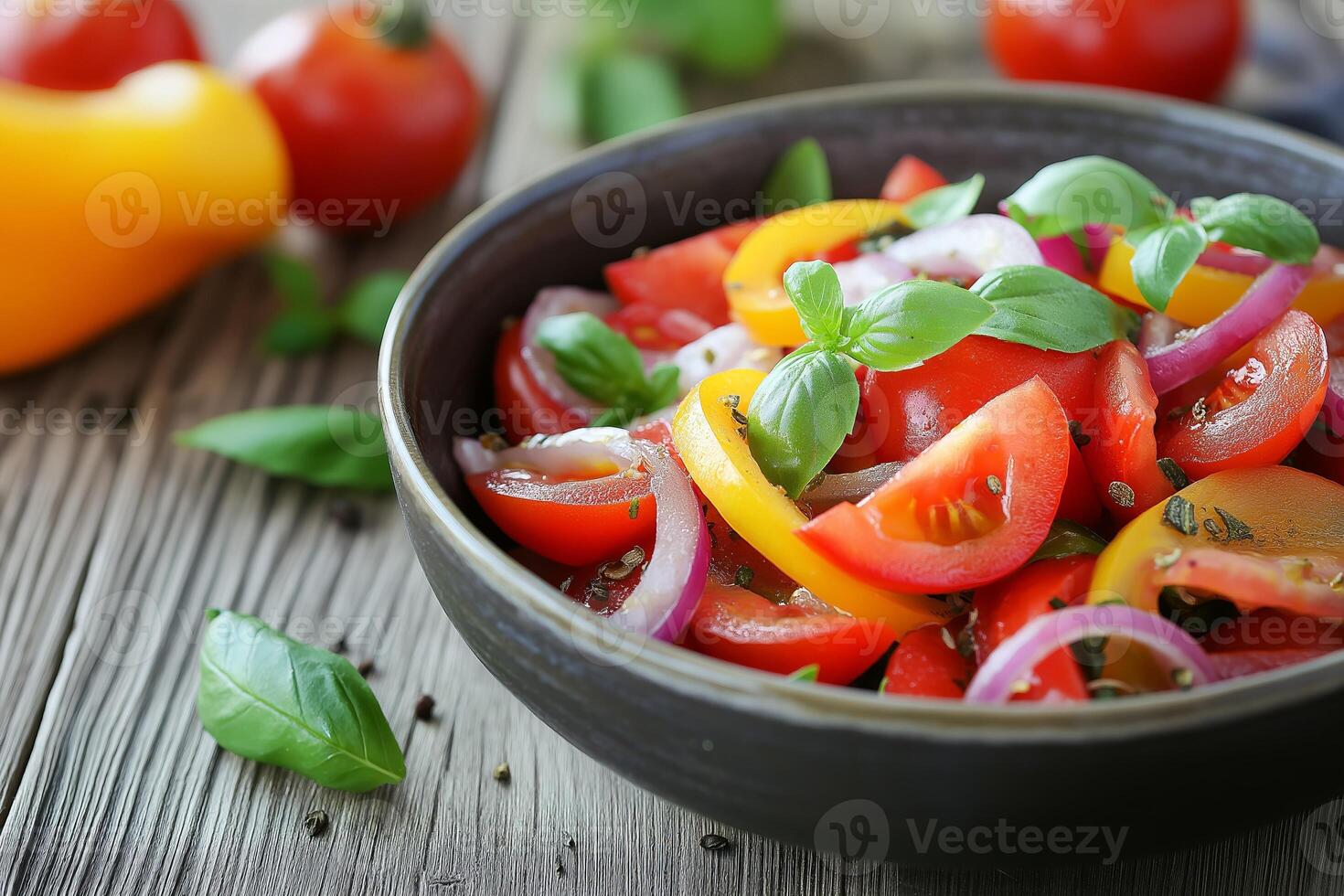 Fresh tomato salad with basil and red onion on rustic wooden table photo