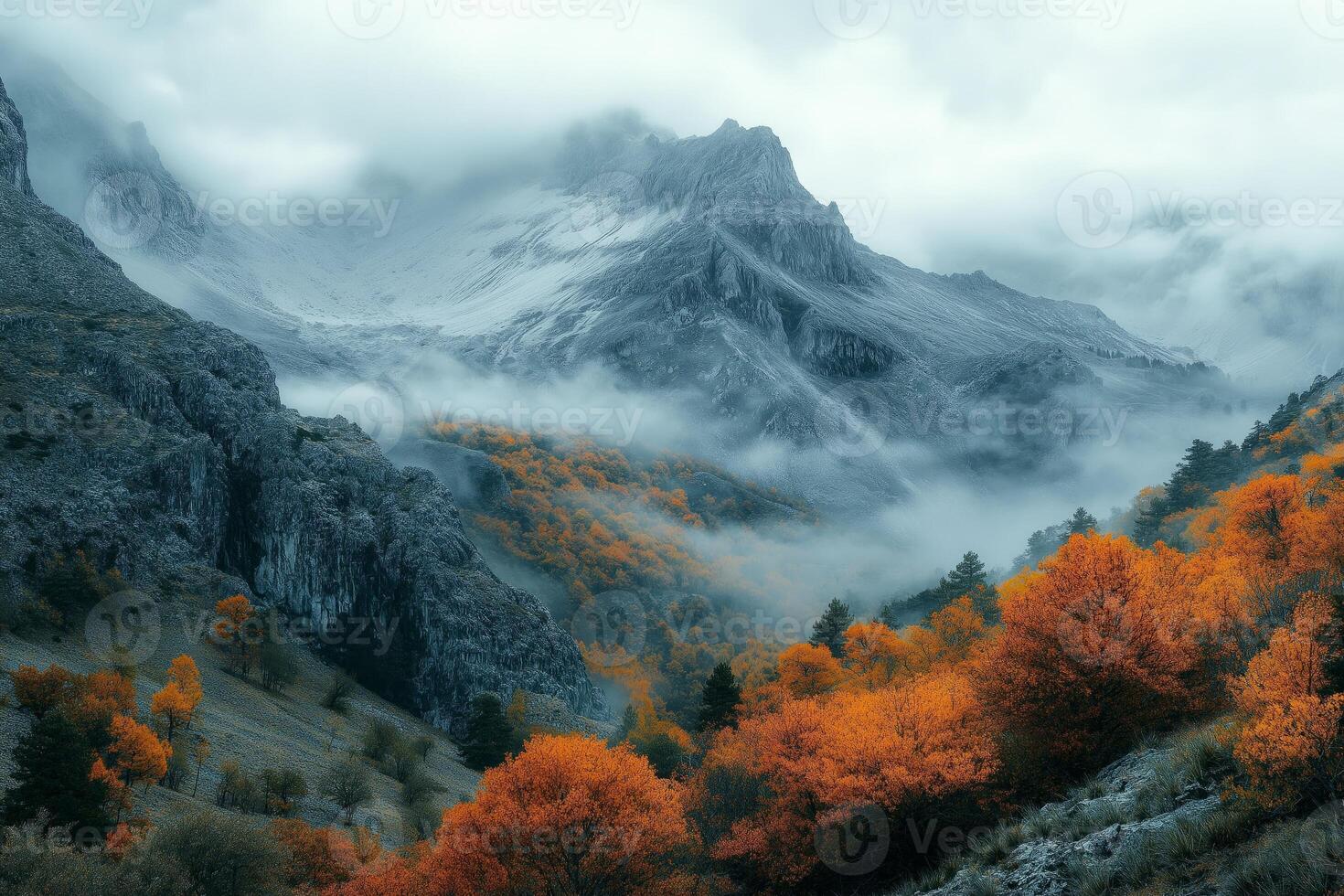 Fog rolling over majestic mountains with colorful autumn trees photo
