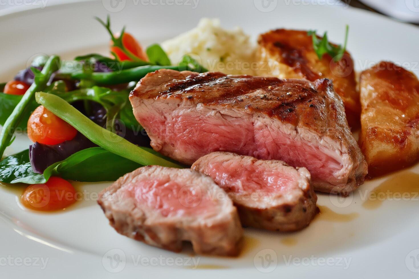 Sliced grilled steak with potatoes and salad on white plate photo