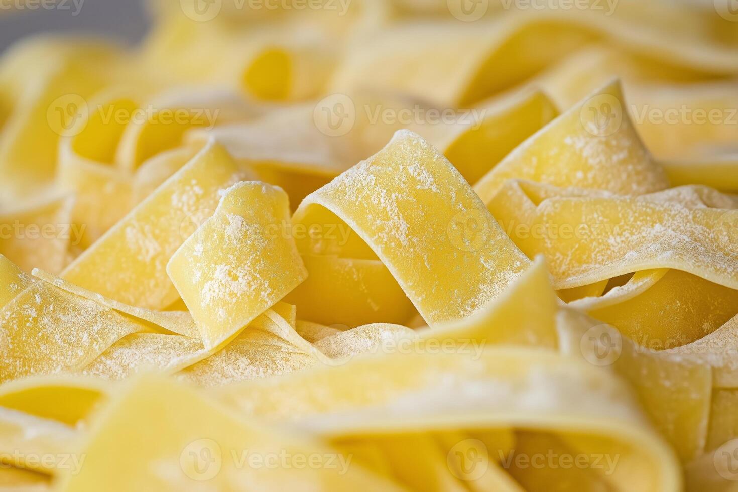 Fresh pappardelle pasta forming appealing ribbons with flour dusting photo