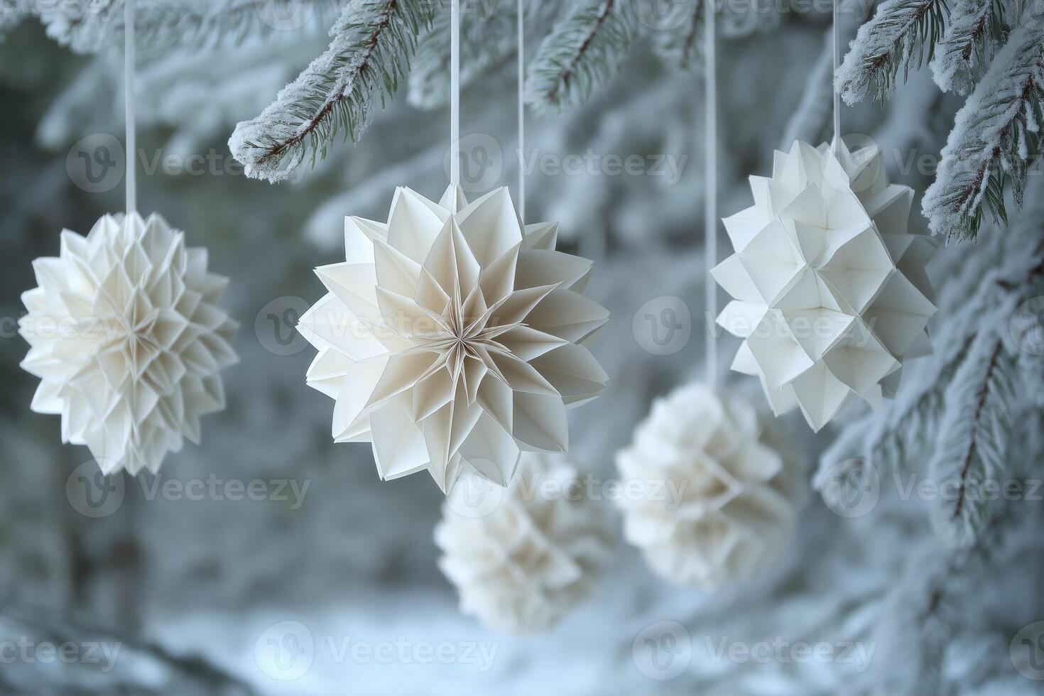Paper flowers hanging from a tree in the snow photo
