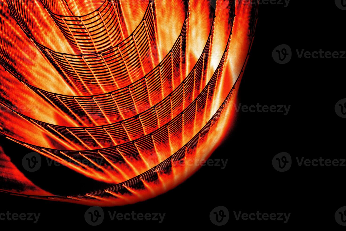 Abstract spiral with glowing red and orange tones and wire texture against a black background, symbolizing energy, motion, industrial and futuristic design concepts. Copy space photo
