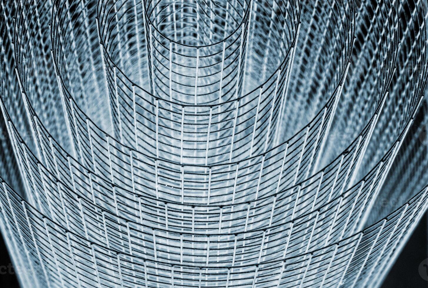 Abstract spiral metal coiled wire mesh with grid pattern, geometric symmetry, modern minimal design for industrial construction, diy, architectural concepts. Isolated on white background. Copy space photo
