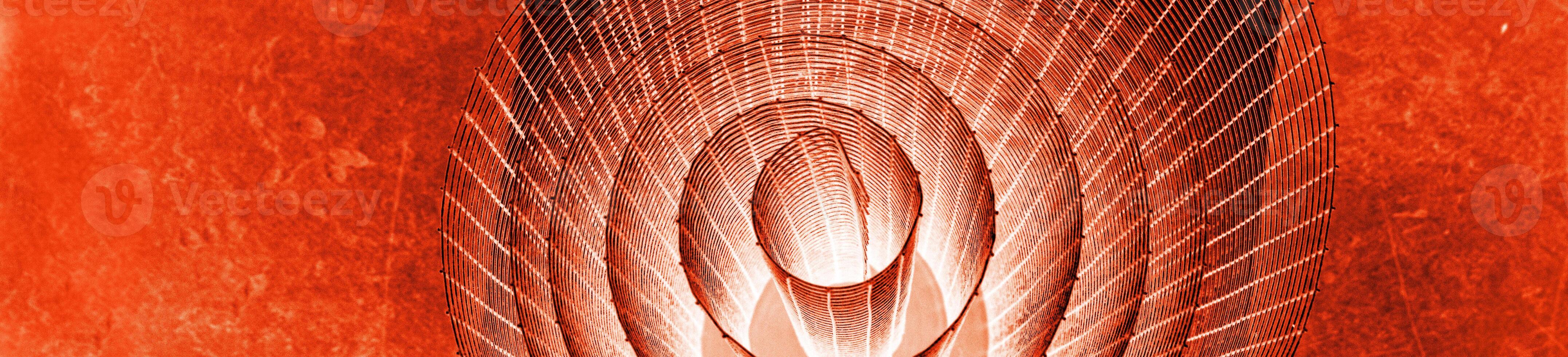 Abstract banner with spiral wire texture with glowing red and orange tones against vivid background, symbolizing energy, motion, industrial and futuristic design concepts. Copy space photo