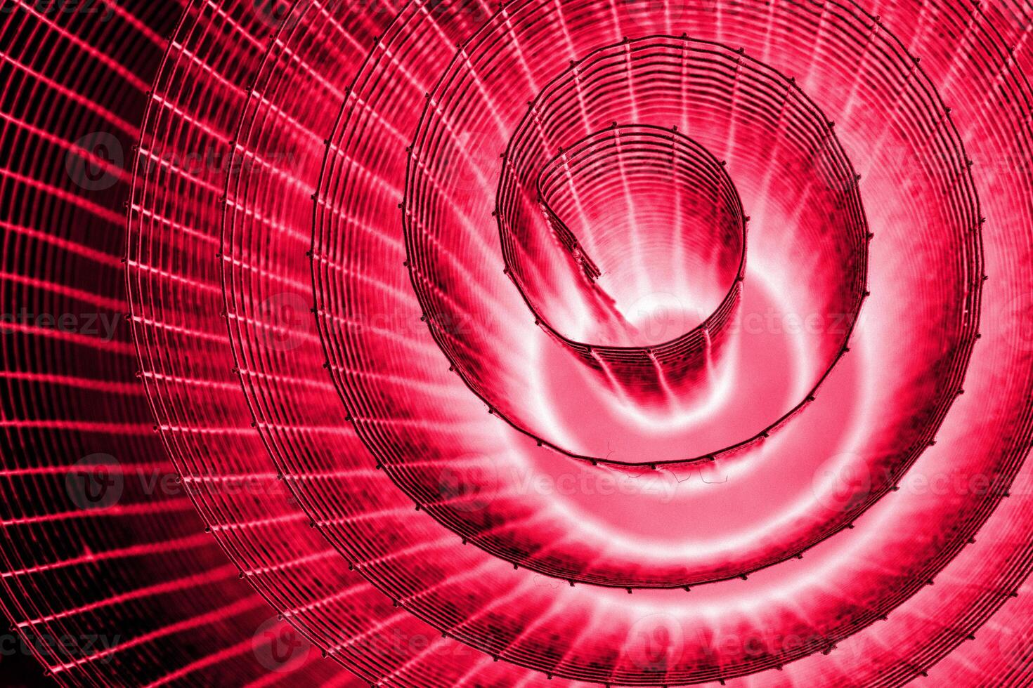Abstract spiral with glowing pink purple wire texture against a black background, symbolizing color contrast, energy, motion, industrial and futuristic design concepts. Copy space photo