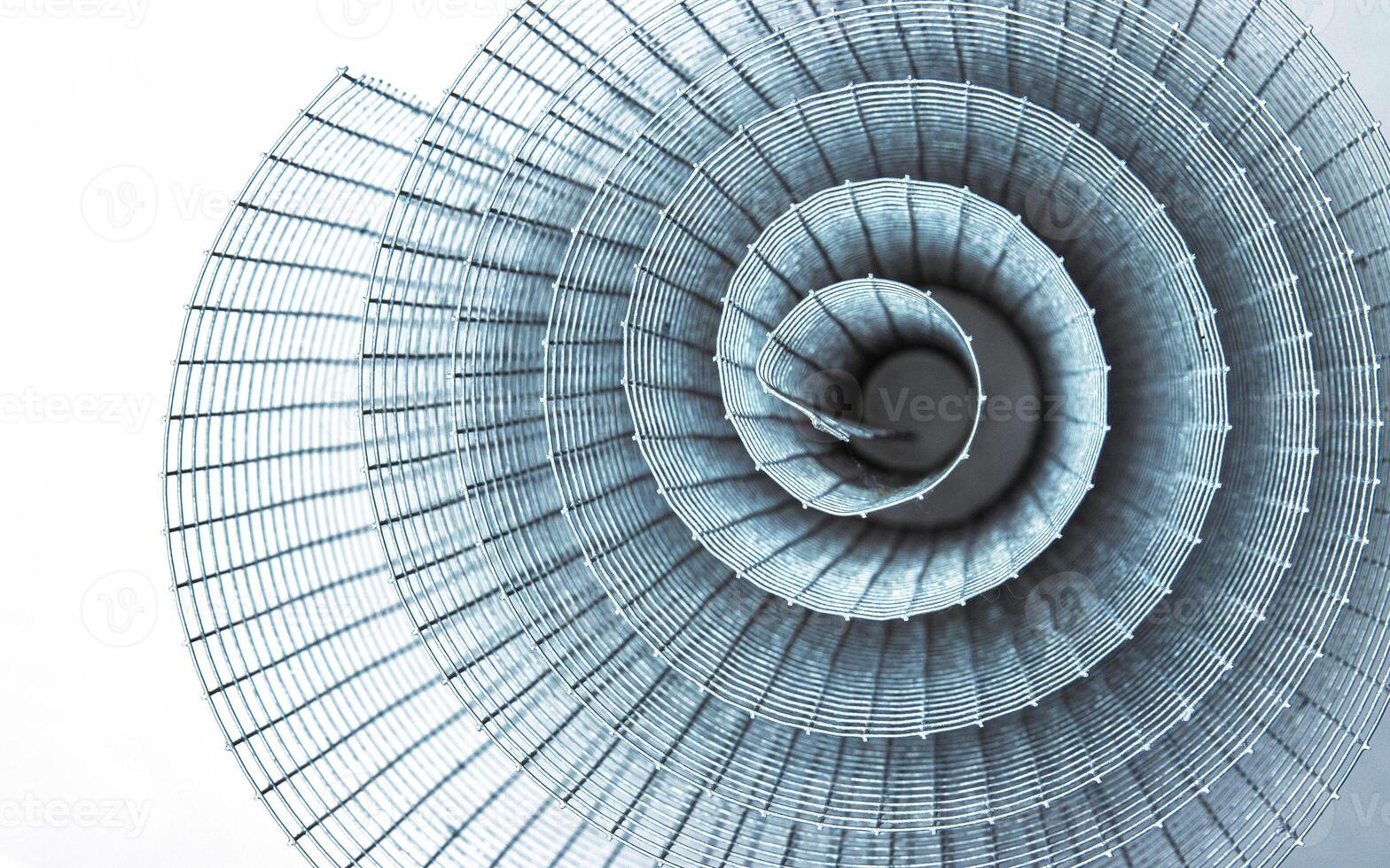 Abstract spiral metal coiled wire mesh with grid pattern, geometric symmetry, modern minimal design for industrial construction, diy, architectural concepts. Isolated on white background. Copy space photo