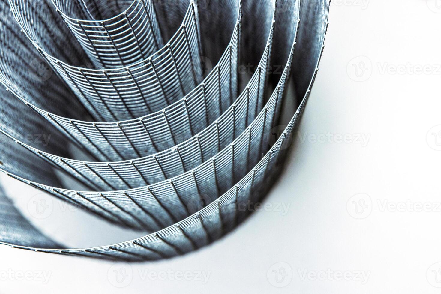 Abstract spiral metal coiled wire mesh with grid pattern, geometric symmetry, modern minimal design for industrial construction, diy, architectural concepts. Isolated on white background. Copy space photo