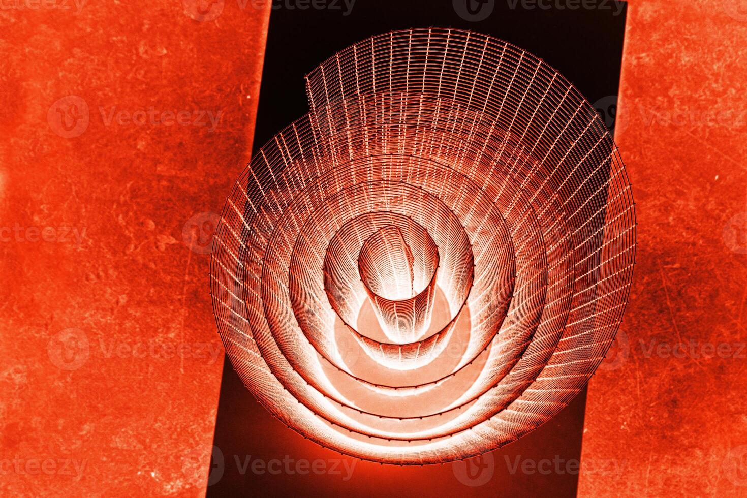 Abstract spiral with glowing red and orange tones and wire texture against a black background, symbolizing energy, motion, industrial and futuristic design concepts. Copy space photo