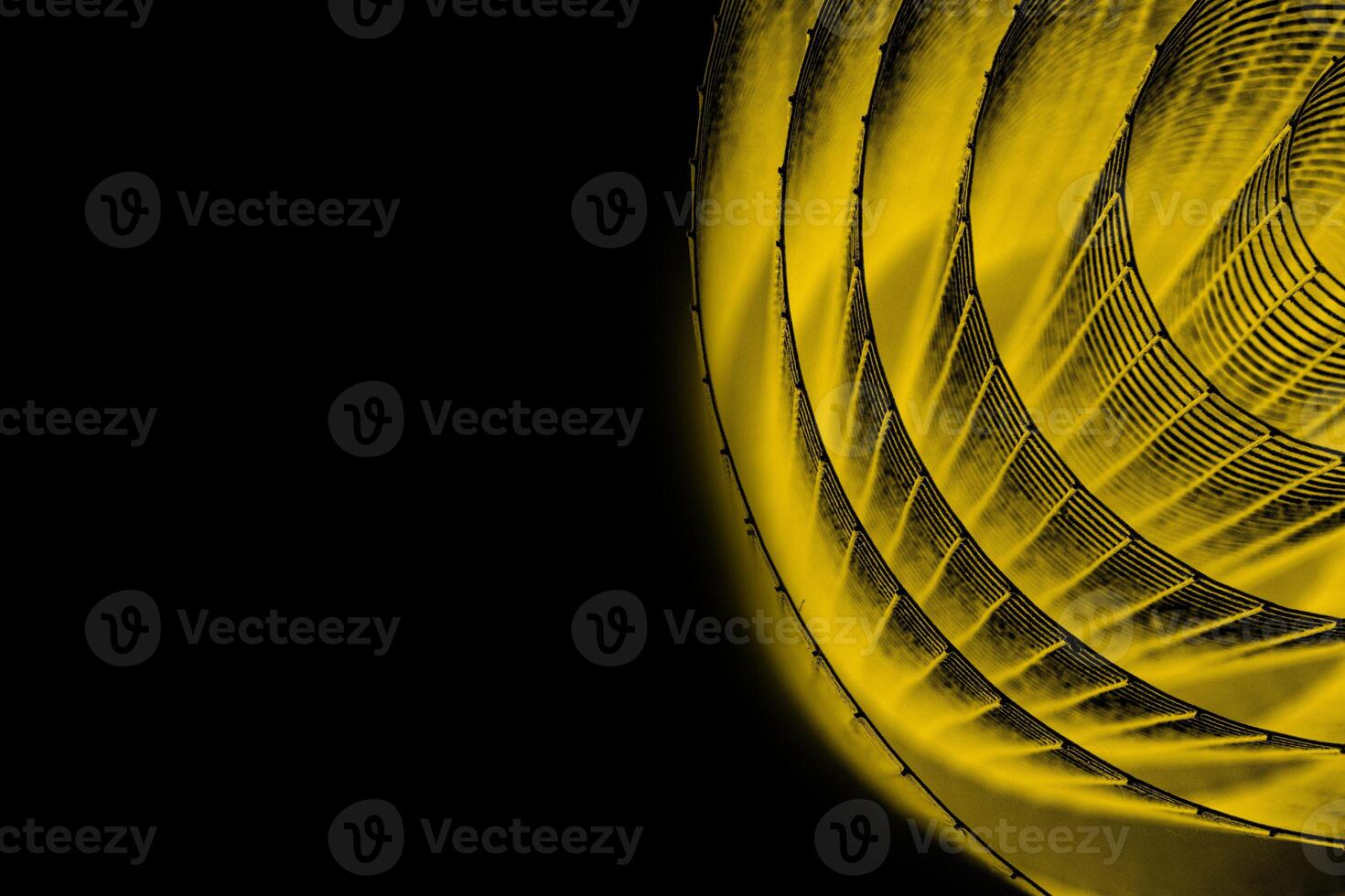 Abstract spiral with glowing yellow wire texture against a black background, symbolizing color contrast, energy, motion, industrial and futuristic design concepts. Copy space photo