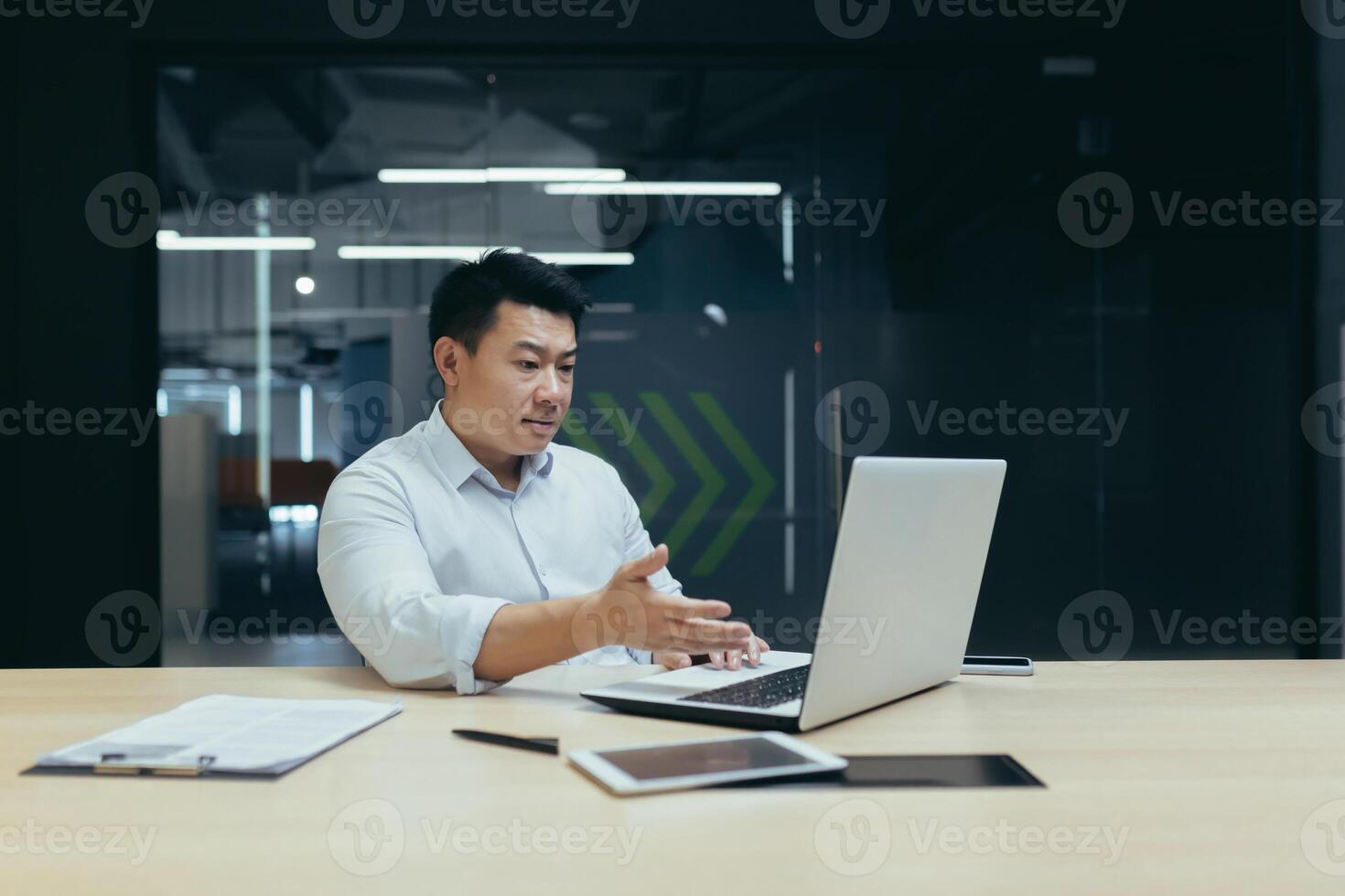 Online consultation with the client. A young male office worker, a sales and service manager communicates via call from a laptop. photo