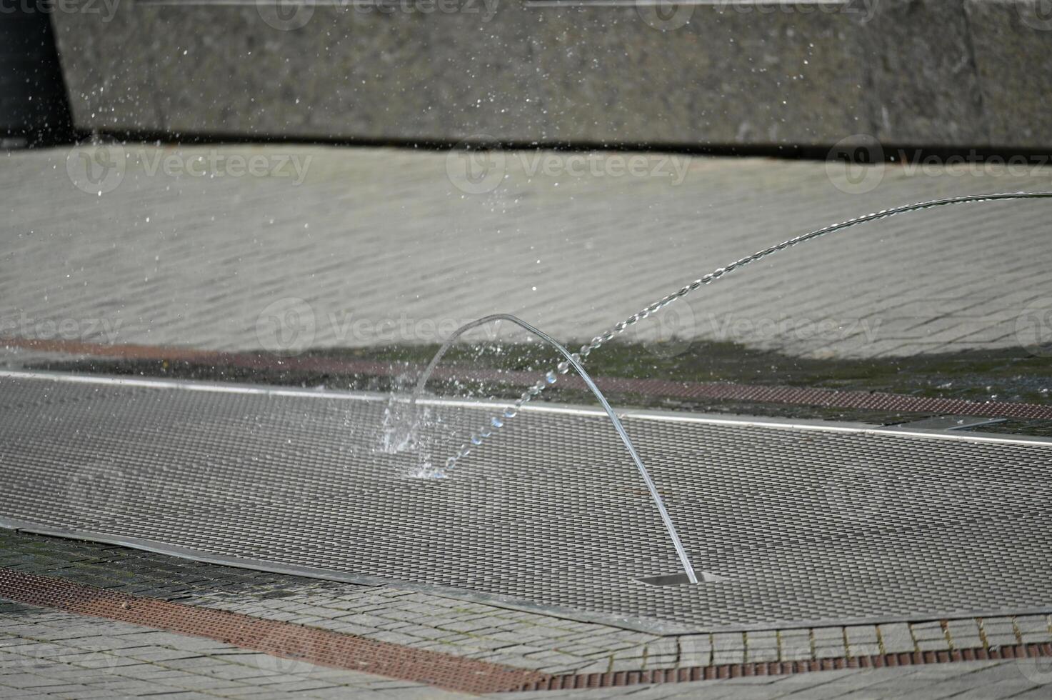 a man is playing with a water fountain photo