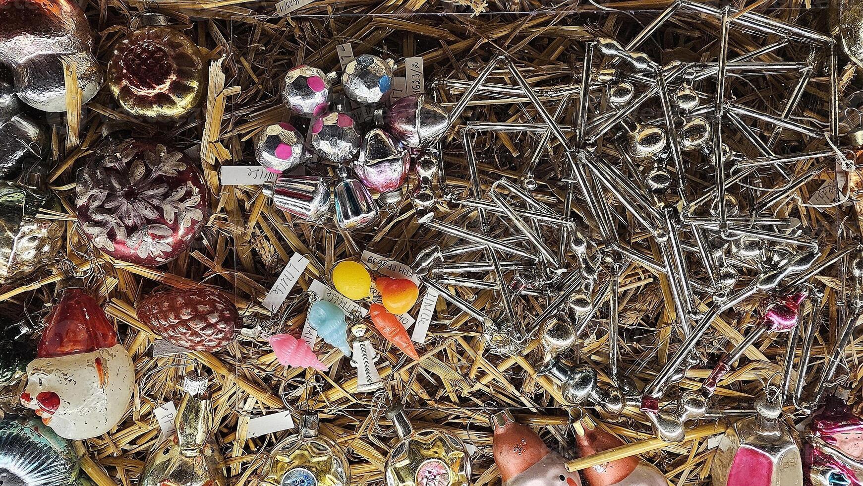 a pile of various ornaments on a hay bale photo