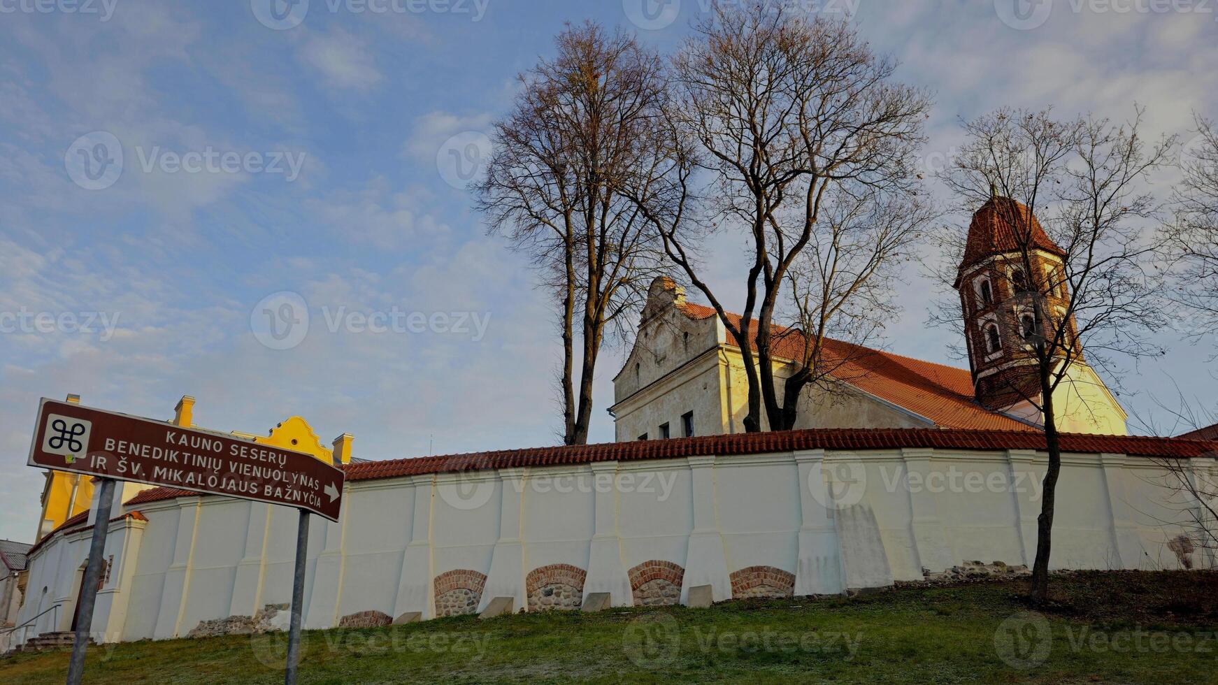 a church with a steeple and a sign on it photo