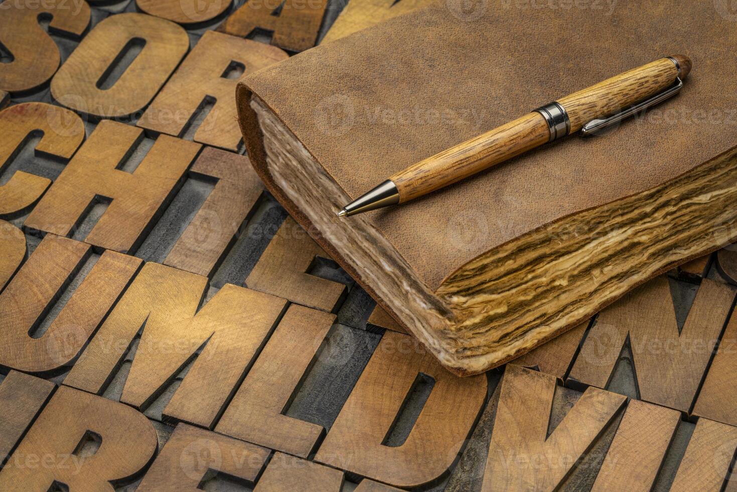 retro leatherbound journal on wood type alphabet photo